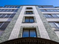 Fragment of the facade of a modern five-story brick apartment building