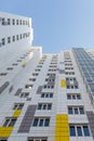 A fragment of the facade of a multi-storey building. White-gray ventilated facade of a modern unrecognizable building