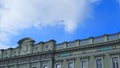 A fragment of the facade of an old building with the coat of arms of the city against Royalty Free Stock Photo