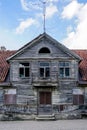 Fragment of the facade of an old wooden house with a clay roof Royalty Free Stock Photo