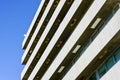 Fragment of the facade of a white office building on a background of blue sky Royalty Free Stock Photo