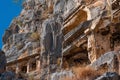 Fragment of famous complex of rock tombs in the ruins of Myra of Lycia with reliefs on the cliff