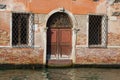 Fragment of the faÃÂ§ade of the flooded old house. Venice, Italy Royalty Free Stock Photo