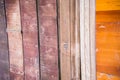 A fragment of a fence made of old brown polished boards and planks.Old wooden surface.Texture, background, close up Royalty Free Stock Photo