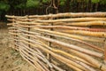 Fence made of wooden rods. Royalty Free Stock Photo