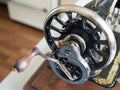 Fragment of first hand SINGER sewing machine, flywheel, selective focus Royalty Free Stock Photo