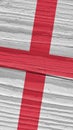 Fragment of the flag of England on dry wooden surface, cracked with age. It seems to flutter in the wind. Mobile phone wallpaper Royalty Free Stock Photo