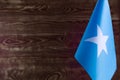 Fragment of the flag of the Federal Republic of Somalia in the foreground space for text blurred background