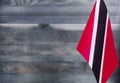 Fragment of the flag of the Republic of Trinidad and Tobago in the foreground blurred light background copy space