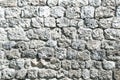 Fragment of a fortified wall made of stones and cemented with cement mortar. Black and white Royalty Free Stock Photo