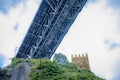 A fragment of the fortress tower and Maria Pia Bridge over the river Duoro in Porto, Portugal, built in 1877 and attributed to