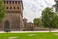 Fragment of the fortress wall, the moat and corner tower of the Sforzesco Castle in Milan, Italy