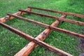 Fragment of the foundation of a wooden frame house on screw metal piles. Construction site