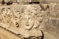 Antique frieze with stone-cut mask in the ruins of the ancient city of Myra, Turkey Royalty Free Stock Photo