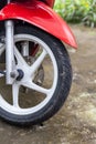 Fragment of front wheel with disc brakes of a red scooter. Royalty Free Stock Photo