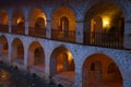 Fragment of the gallery of the building of an ancient caravanserai in the evening twilight. Sheki, Azerbaijan Royalty Free Stock Photo