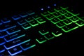 Fragment of the game keyboard with color backlight on black background. Close-up of computer keyboard. Royalty Free Stock Photo