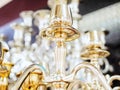 Fragment of golden shiny candelabrum on blurred background