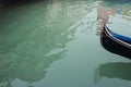 Fragment of a gondola sailing through a channel in Venice Royalty Free Stock Photo