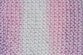 Fragment of handmade seamless knitted patterns in mixed pastel colors closeup