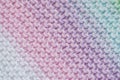 Fragment of handmade seamless knitted patterns in mixed pastel colors