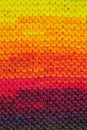 Fragment of handmade seamless knitted patterns in rainbow colors mix