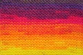 Fragment of handmade seamless knitted patterns in rainbow sunset colors mix