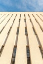 Fragment of a  high-rise modern building against the blue sky, view from below Royalty Free Stock Photo