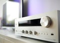 Fragment of the home stereo mini Hi-Fi music system with metal volume control knob on a foreground close-up at selective focus Royalty Free Stock Photo