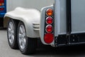 Fragment of a horse trailer for a car with wheels and taillights. Travel with animals Royalty Free Stock Photo