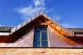 A fragment of a house facade lined with copper plates