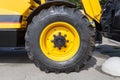 A fragment of a huge wheel and tire of construction equipment.