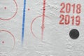 Fragment of ice hockey arena with markings and puck