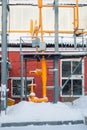 Fragment of an industrial gas pipeline with valves outdoors in winter