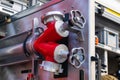 Fragment of the inside of a fire engine with valves for connecting water hoses. Royalty Free Stock Photo