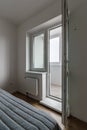 Fragment of the inside of a small bedroom with access to the balcony Royalty Free Stock Photo