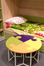 Fragment interior children's room with a table in form of puzzle Royalty Free Stock Photo
