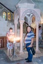 Fragment of the interior of the Church of the Holy Sepulchre in Jerusalem, Israel. Believers light candles. Royalty Free Stock Photo