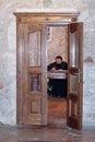 Fragment of the interior of the Church of the Holy Sepulchre in Jerusalem, Israel. The church minister is sitting at the desk and Royalty Free Stock Photo