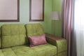 Fragment of the interior with a green sofa and picture cards Royalty Free Stock Photo