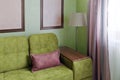 Fragment of the interior with a green sofa and picture cards Royalty Free Stock Photo