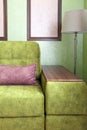 Fragment of the interior with a green sofa and picture cards Royalty Free Stock Photo