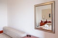 A fragment of the interior of a hotel room. The mirror reflects the decoration of the room Royalty Free Stock Photo