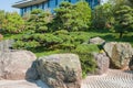 Fragment of Japanese Zen Garden with giant volcanic stones,ornamental trees and slanted mini pine Royalty Free Stock Photo