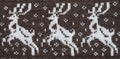 Fragment of a knitted fabric of handkerchief hand-knitted brown wool. Figure winter Christmas theme. White deer. View from above.