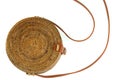Fragment of ladies` wicker bag with a brown strap isolated on white