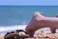 Fragment of legs on the beach close-up. Royalty Free Stock Photo