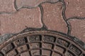 A fragment of the lid of the well and the pavement. Abstract background. Soft focus Royalty Free Stock Photo