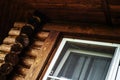 Fragment of a log house with plastic windows. Selective focus. Close-up Royalty Free Stock Photo