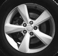 Fragment of luxury car with wheel on steel disc, closeup photo Royalty Free Stock Photo